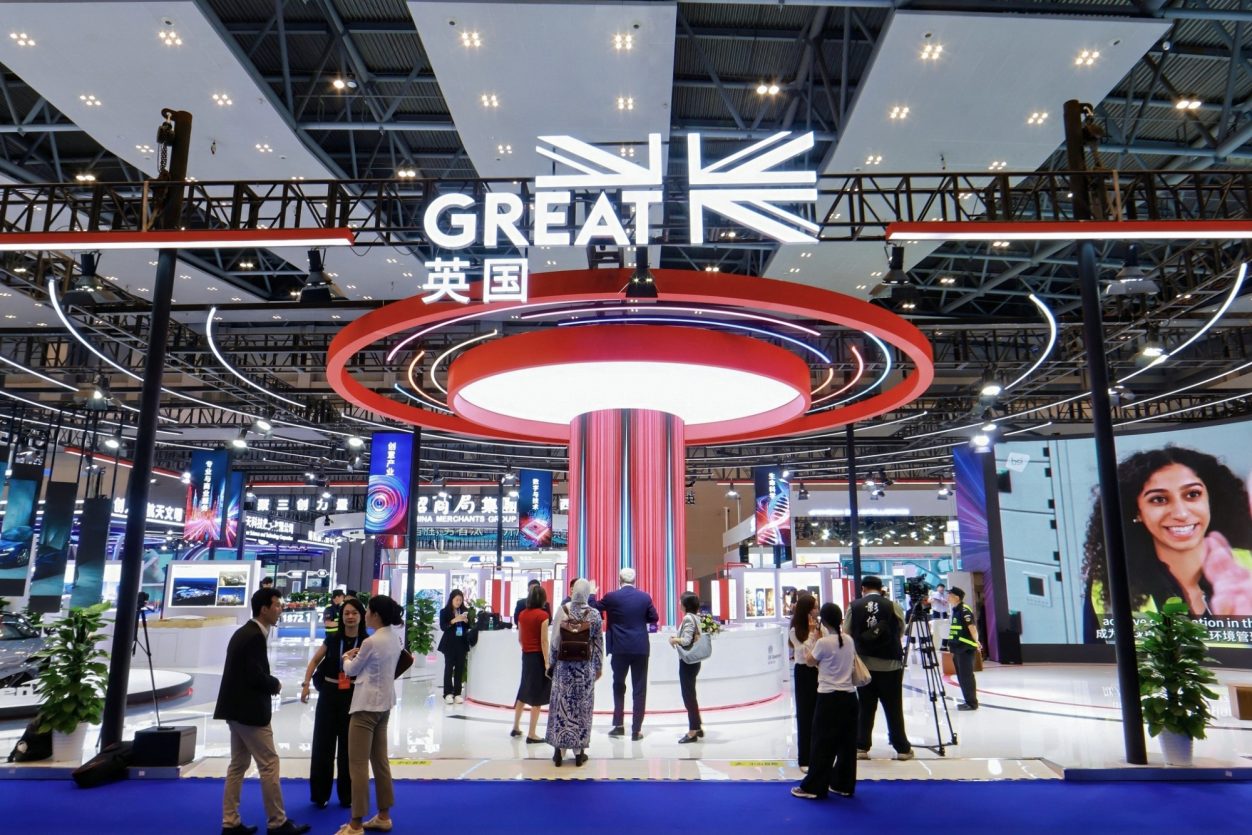 British exhibition stand with "GREAT" signage, featuring visitors and various displays.